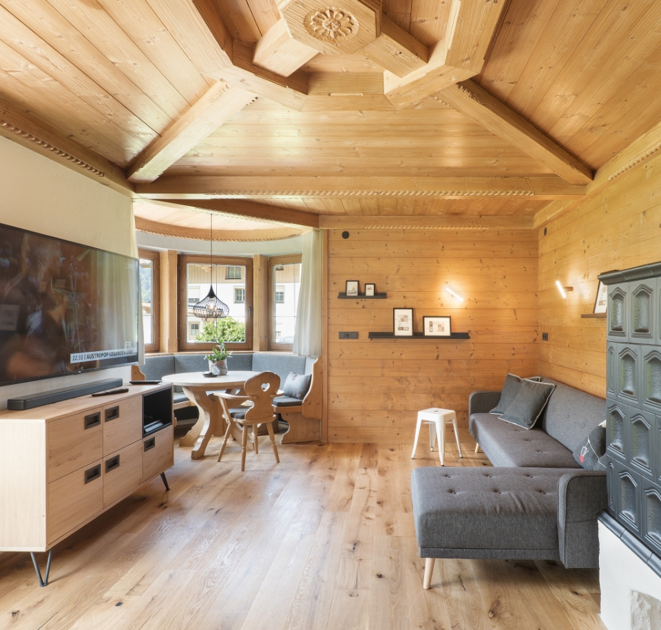 the cozy living room with tv, sofa and tiled fireplace